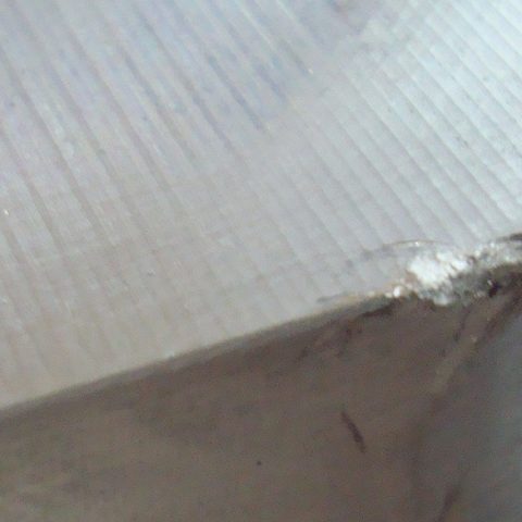 Damaged edge on workpiece