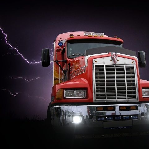 Red truck in front of black thunderstorm clouds
